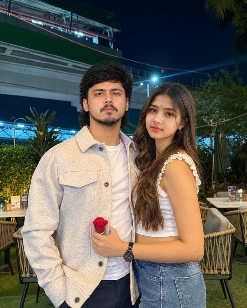 Romantic Nighttime Couple Portrait with Red Rose