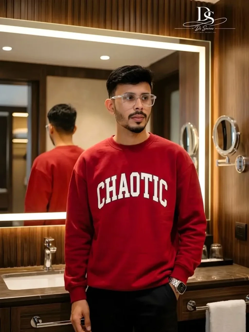 Young Man in Crimson Sweatshirt Standing in Modern Illuminated Vanity Room