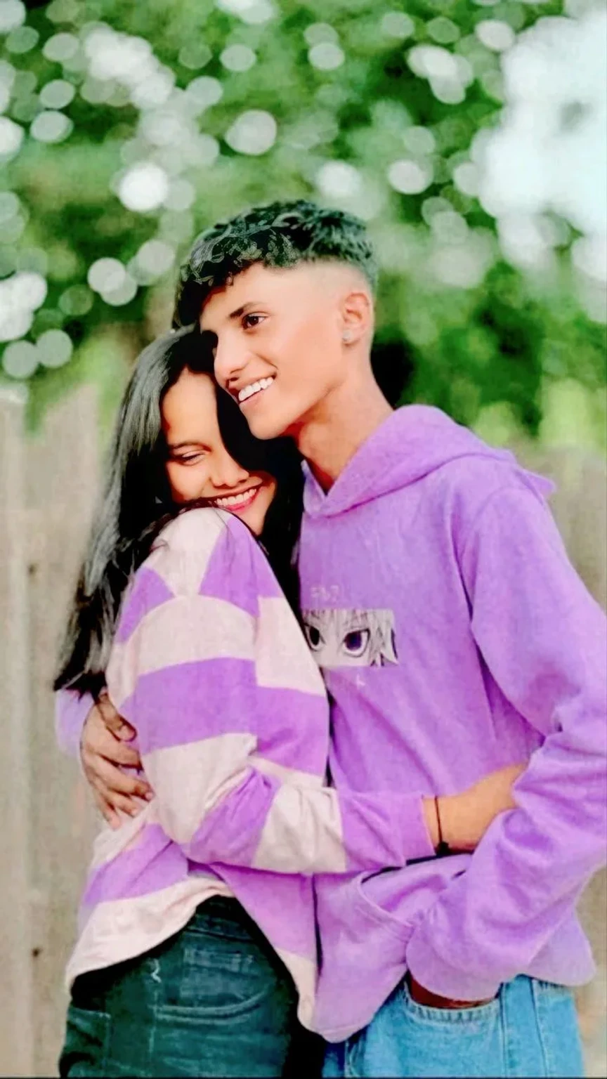 Candid Outdoor Portrait of Young Couple Hugging in Lavender Casuals