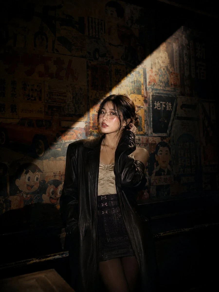 Cinematic Nighttime Portrait of a Stylish Young Asian Woman Standing on