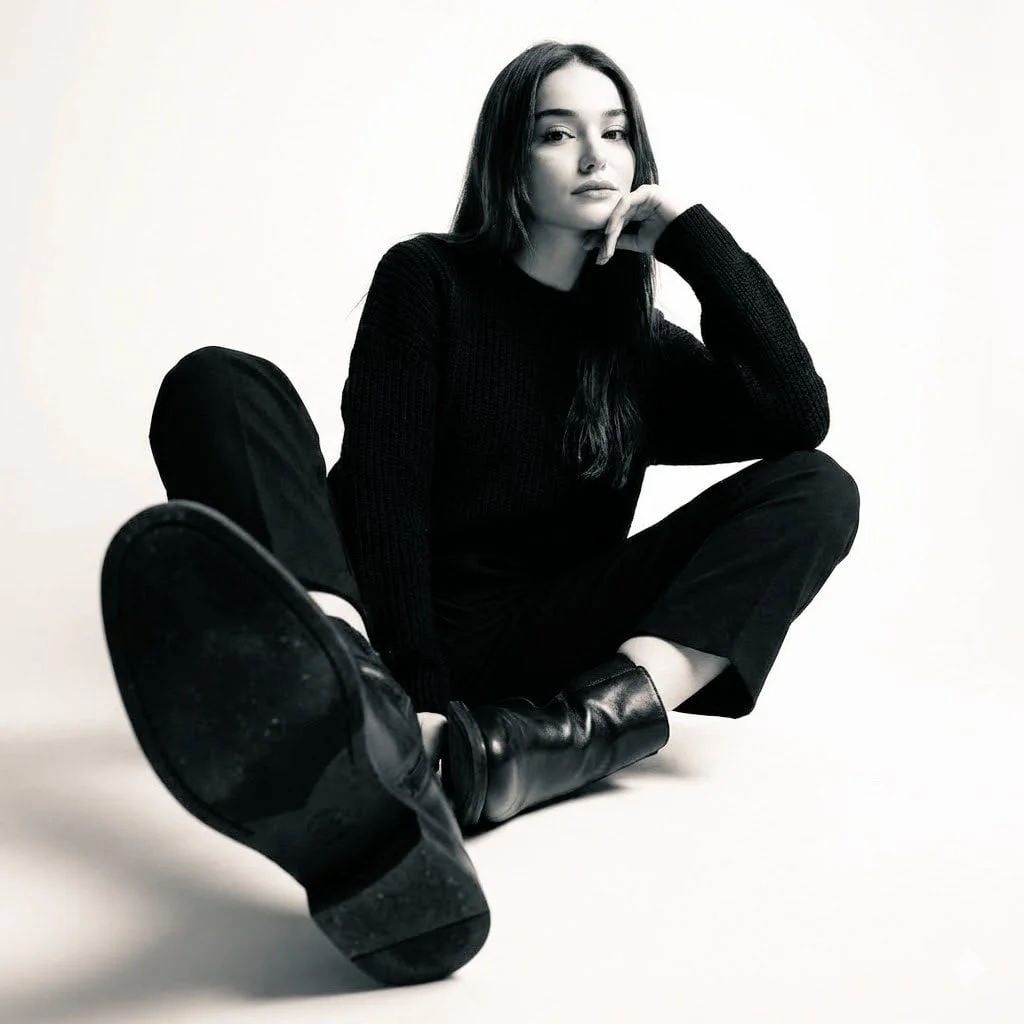 High-contrast black-and-white studio photo of a woman